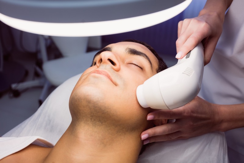Man getting a facial massage for cosmetic treatment at clinic